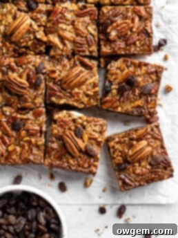 Pecan pie bar with raisins and shortbread crust, garnished with powdered sugar