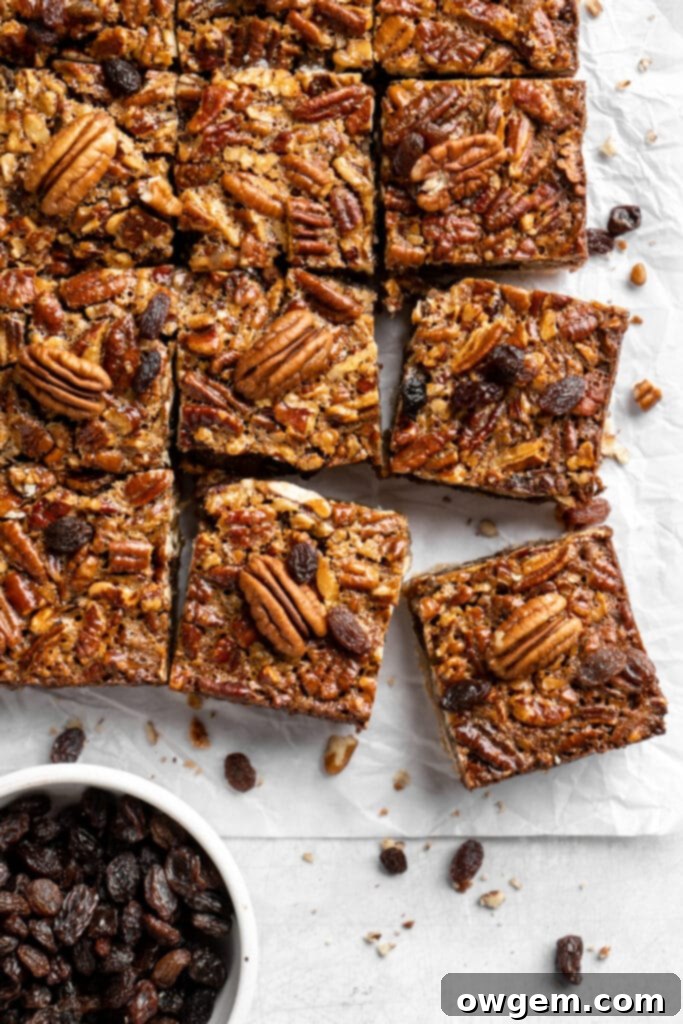 A bowl of pecan pie filling with raisins and chopped pecans, ready to be poured
