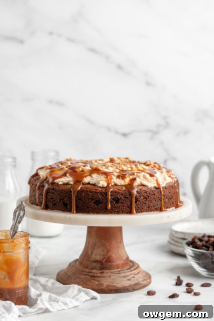 Caramel raisin spice cake on cake stand.