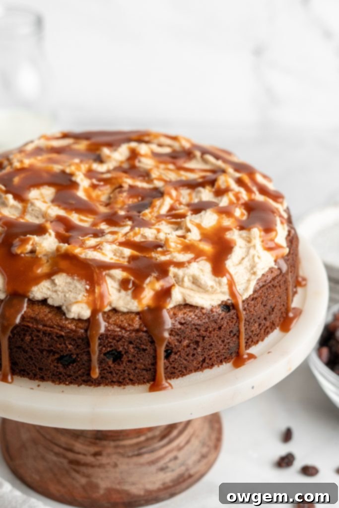 Caramel raisin spice cake, caramel drizzling down the side.