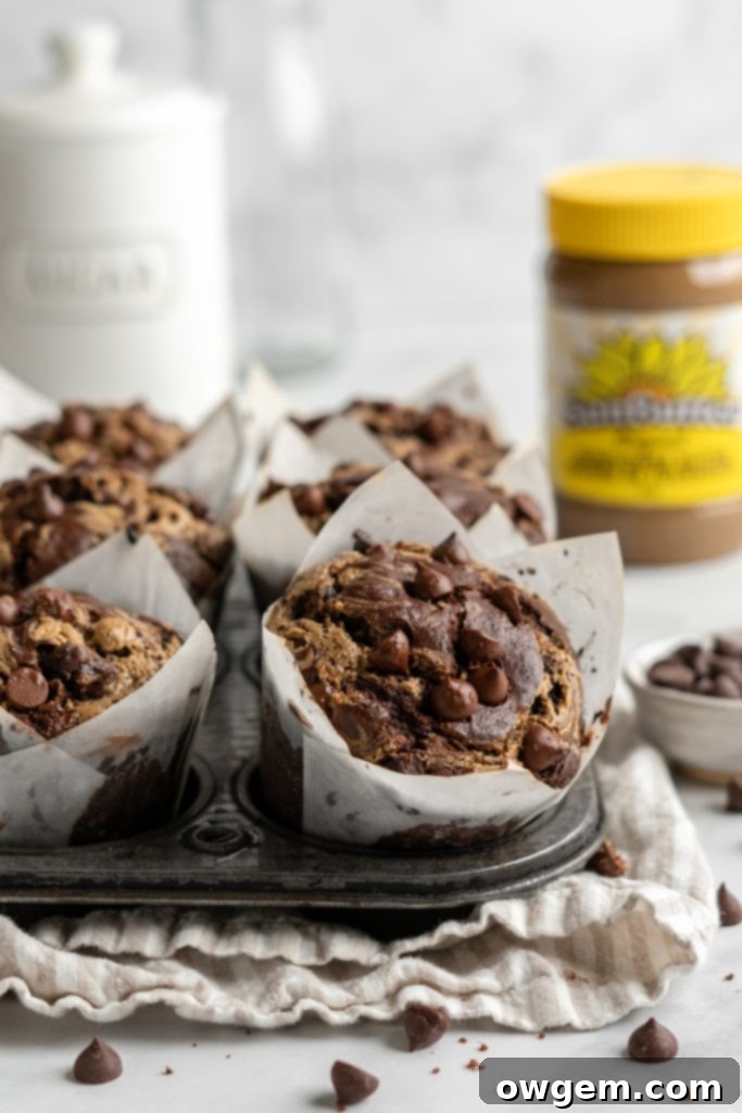 Bakery style double chocolate chip muffin batter looking tall and fluffy in a pan, ready for baking.
