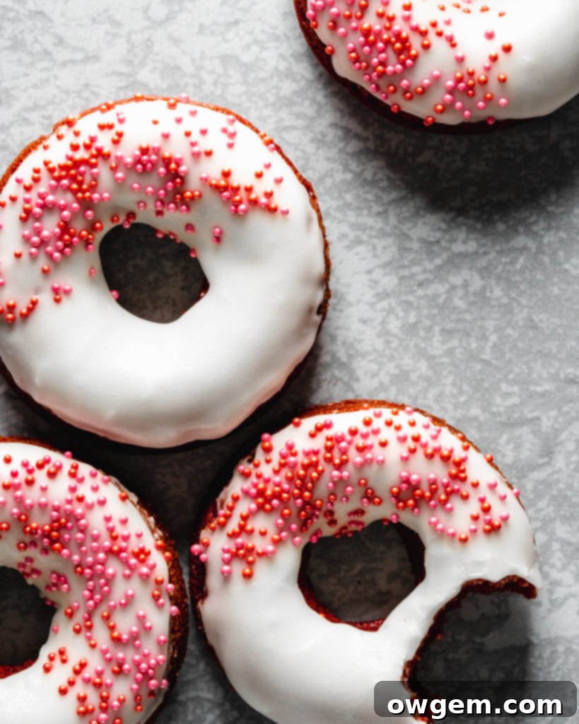 Easy to make baked red velvet donuts are glazed with a cream cheese frosting