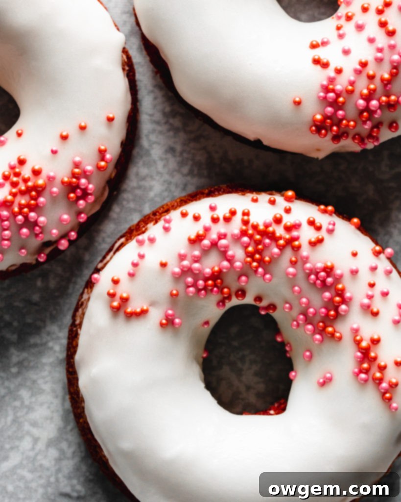 Easy to make baked red velvet donuts are glazed with a cream cheese frosting
