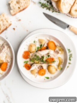 A visually appealing bowl of creamy chicken and potato soup, garnished with herbs, ready to warm you up.