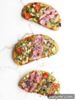 Close-up of a completed sriracha feta avocado toast with all toppings.